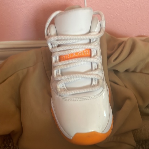 These are Jordan 11s low top. Orange and white. They need a good washing. - Picture 3 of 6